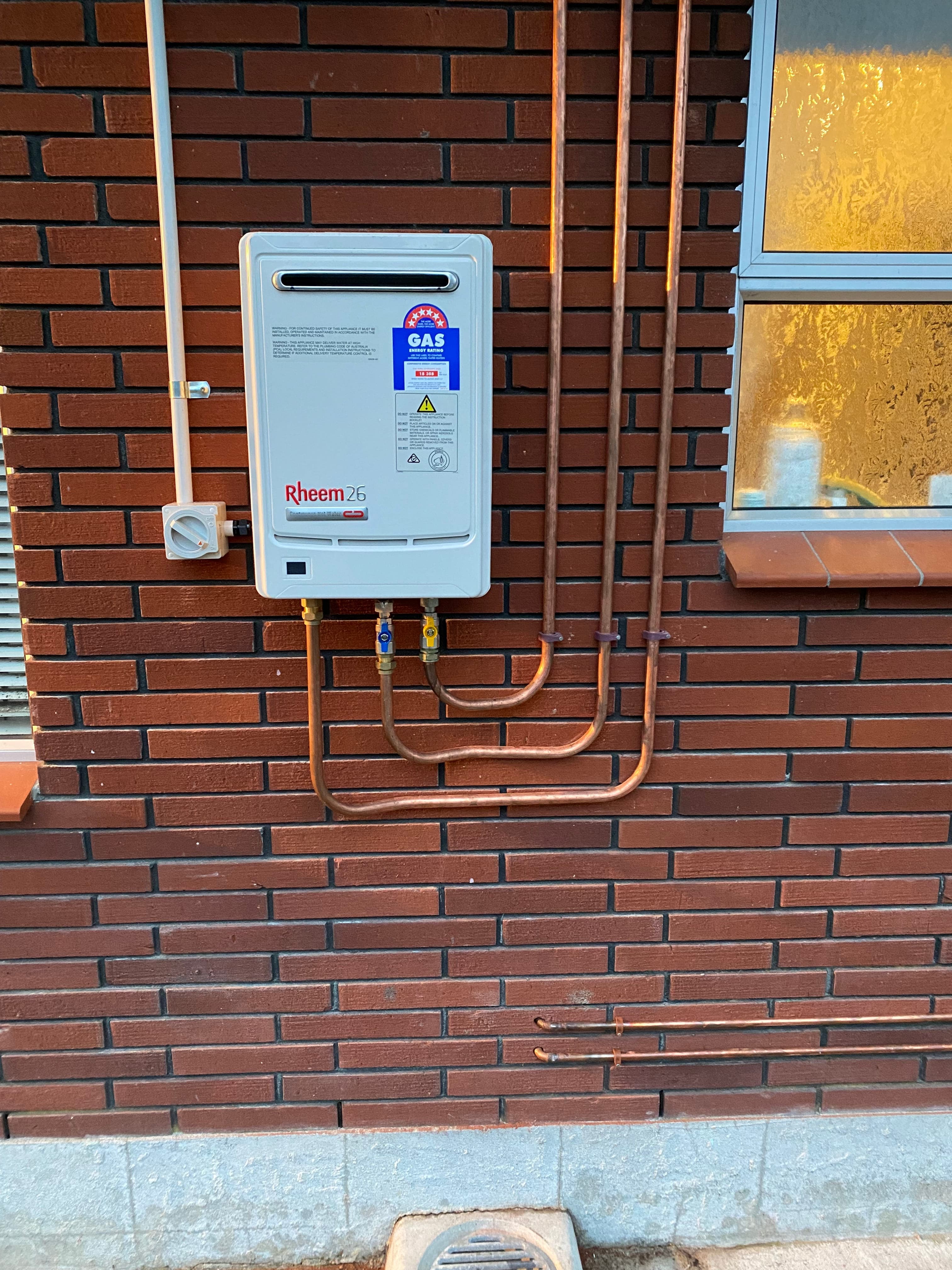 Rheem 26 gas unit on brick exterior
